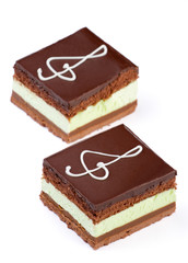 Chocolate cake with a treble clef sign made with cream. Isolated