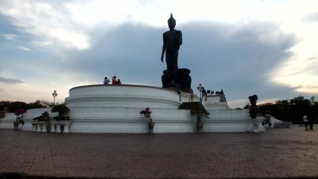 people relaxing around buddha statue monument