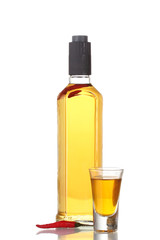 bottle and glass of pepper vodka and red chili pepper isolated