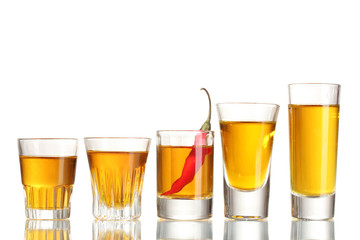 glasses of pepper vodka and red chili pepper isolated on white