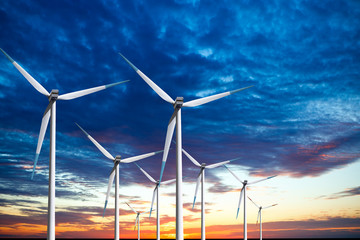 Wind turbines farm at sunset