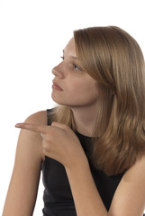 Young teenage girl pointing and looking to the left.