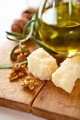 Jug of olive oil, Grana Padano cheese and walnuts