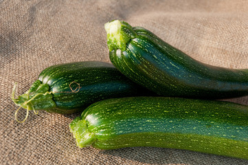 Organic zucchini on sackcloth background
