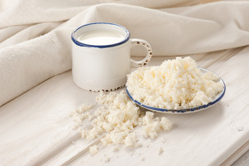 Breakfast with milk and cottage cheese on old wooden table