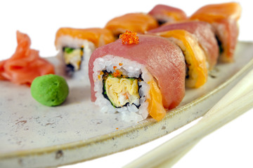 japanese roll closeup with salmon, tuna, tamago, tobiko and crab