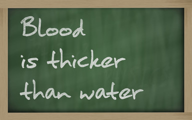 " Blood is thicker than water " written on a blackboard