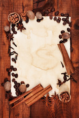 old paper for recipes and spices on wooden table