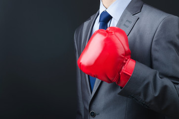 Young businessman with boxing gloves