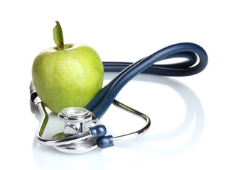 Medical stethoscope and green apple isolated on white