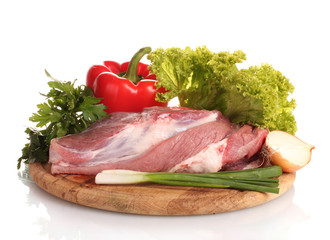 Raw meat and vegetables on a wooden board isolated on whitе