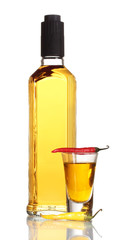 bottle and glass of pepper vodka and red chili peppers isolated