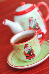 Porcelain tea pot and cup with Christmas ortament