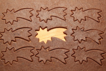 cutting raw dough on Christmas gingerbread