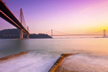 Photo sur Plexiglas Hong Kong Hong Kong bridges at sunset over the ocean