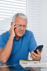 Senior Man Holding Calculator