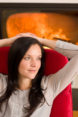 Fototapeta premium Winter home fireplace woman relax red armchair
