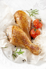 Roasted chicken on a plate with tomatoes