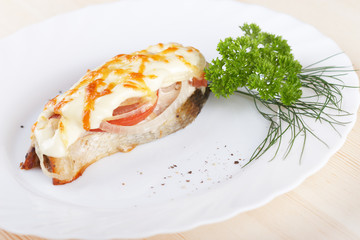 Salmon baked under vegetables and mayonnaise