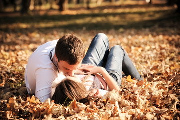 Kissing young couple in love in the autumn park