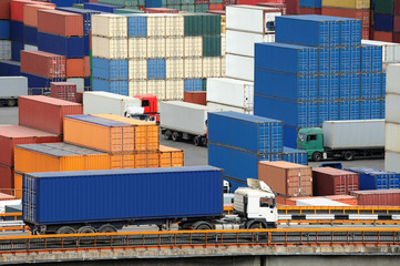 truck carries container to warehouse near the sea