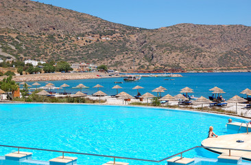 Swimming pool near beach at the modern luxury hotel, Crete, Gree