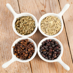 Assorted bowls of spices over wooden table