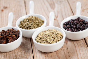 Assorted bowls of spices over wooden table