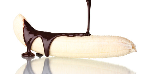 Banana poured with liquid chocolate isolated on white.