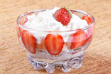 Vase of strawberries with cream