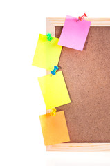 Sticky notes pinned on a cork board frame