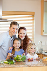 Obraz na płótnie Canvas Family standing in the kitchen