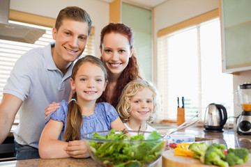 Family standing behind the kitchen counter