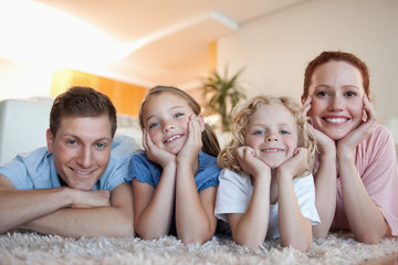 Cheerful family on the carpet