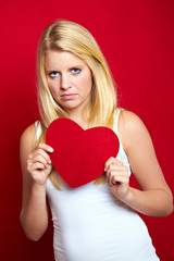 young disappointed woman with a heart