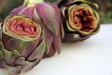 Cut artichokes on white table outdoor