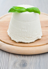 Ricotta cheese with basil leaves.