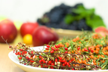 fresh buckthorn with barberry on a background of frui