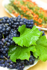 fresh black grape on a background of fruits