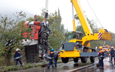 Crane lifting crashed truck