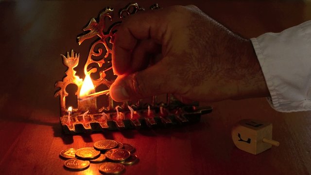 Chanukah - Hand lighting a Menorah