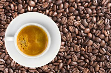 white cup of coffee espresso over coffee beans background