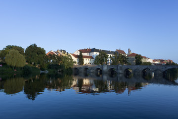 Fototapeta na wymiar old stone bridge at pisek, czech republic, in the late afternoon