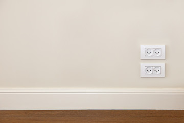 Wall with wooden floor and power outlet