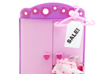 hanger with a price tag sale and doll wardrobe isolated on white