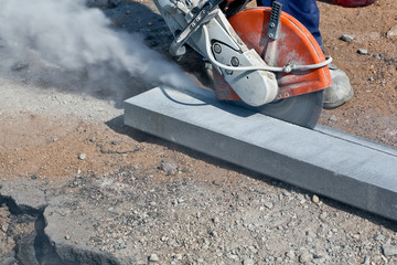 Construction cutting works with petrol driven angle grinder