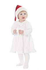The baby girl in santa's hat with a toy