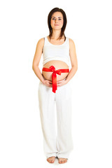 Brunette pregnant woman with red ribbon isolated on white