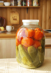 Glass jar with tinned vegetables on a table