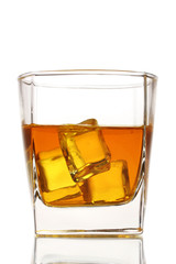Glass of scotch whiskey and ice isolated on white